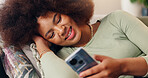 Smile, phone and woman in home online, texting and reading social media blog post to relax. Happy, mobile and African girl on sofa for communication, streaming show and download chat app on internet