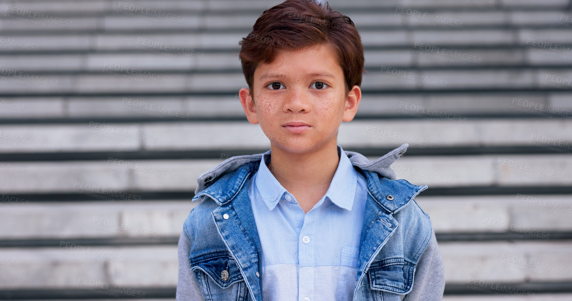 Buy stock photo Young boy, portrait and freckles with fashion on staircase for school, childhood or stylish clothing in city. Child, teenager or face of casual kid with denim jacket, shirt or stairs in an urban town