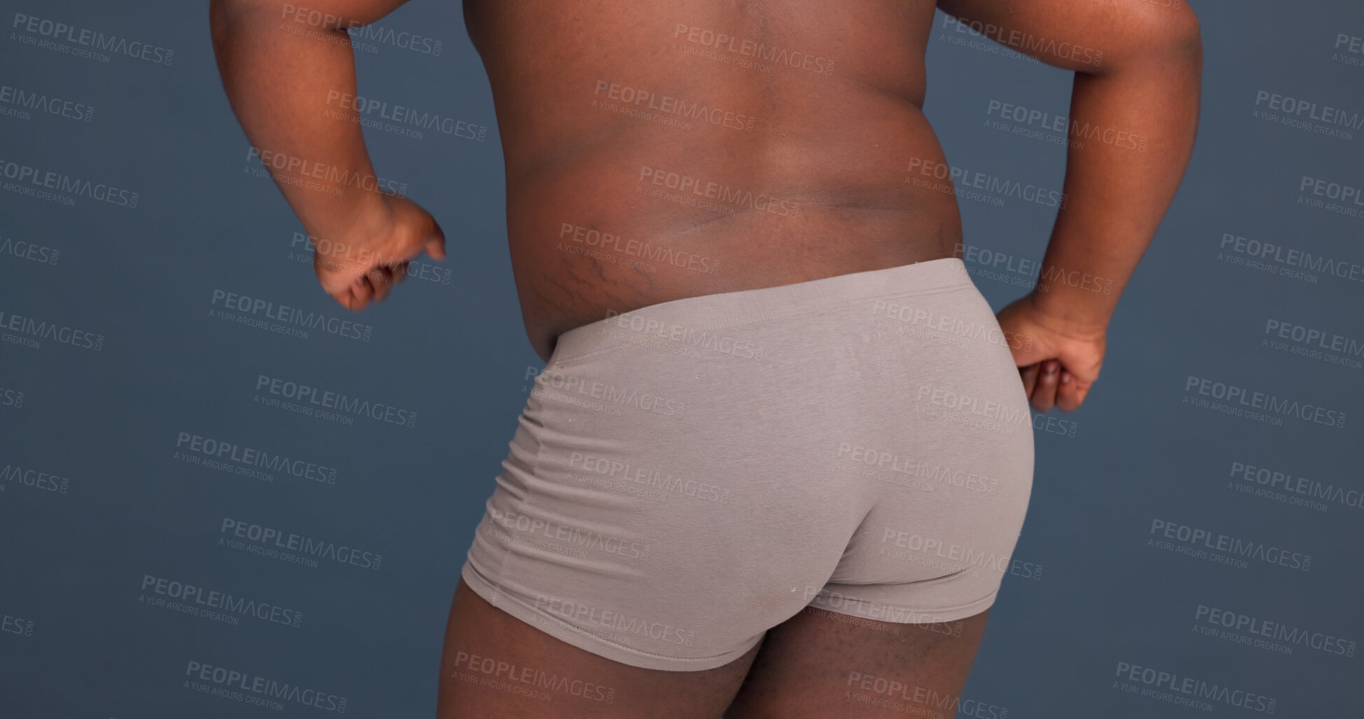 Buy stock photo Back, buttocks and underwear in studio for body positivity, dance and self care. Man, topless and movement on dark background with boxers, freedom and confidence with plus size model or appearance