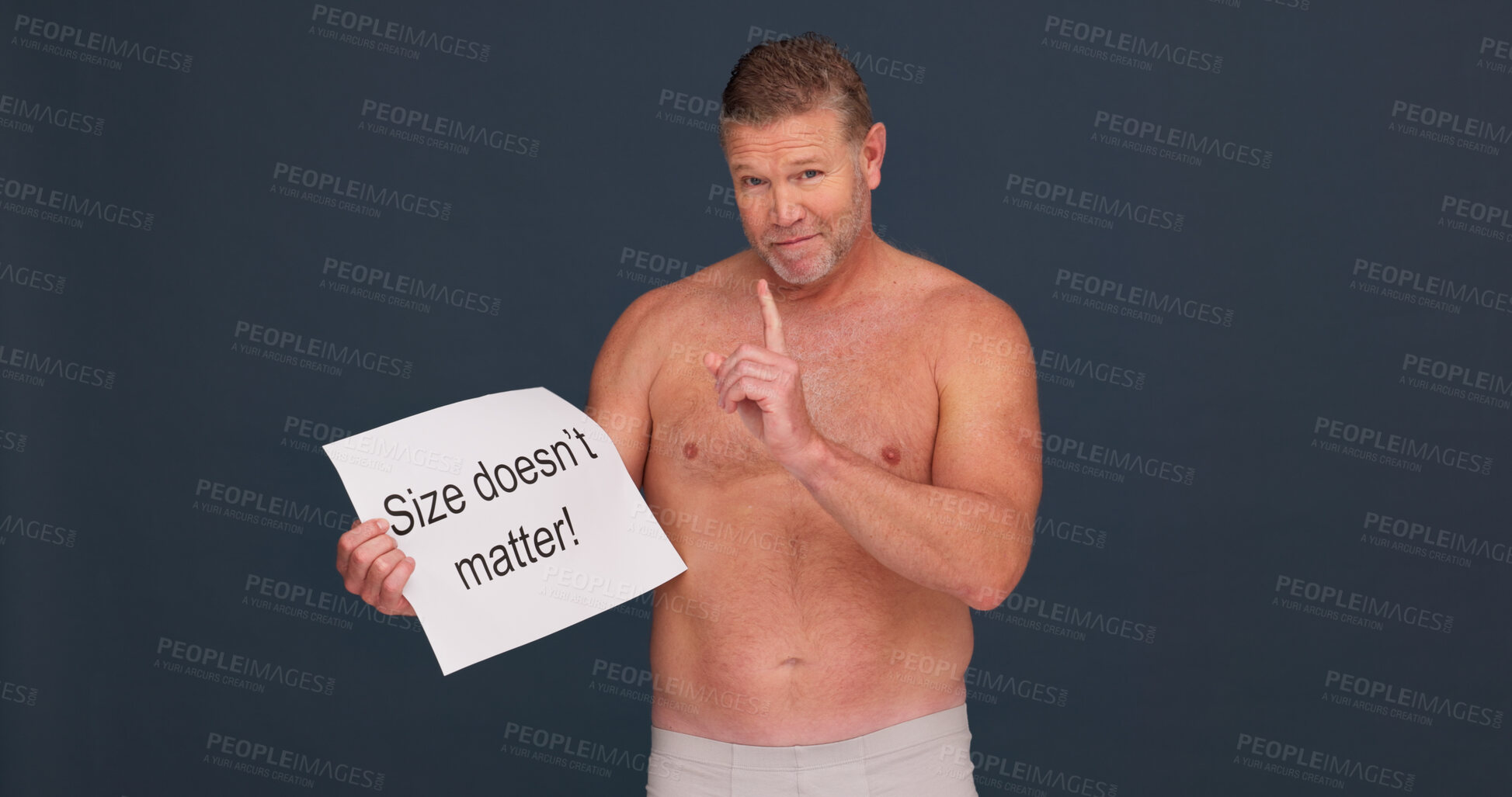 Buy stock photo Portrait, man and poster for body positivity in studio, acceptance or space on dark background. Face, confidence and shirtless person with sign on paper for pride, size or self love message for power