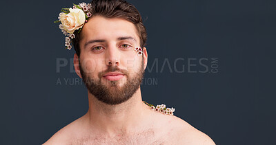 Buy stock photo Portrait, skincare and man in studio with flowers, confidence and natural self care in creative lgbt aesthetic. Nature, floral and male person with gay pride, organic cosmetics and grey background