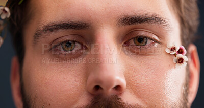 Buy stock photo Closeup, eyes and portrait with man, flowers and makeup with skincare on studio background. Face, queer person and model with beauty, smooth skin and dermatology with organic treatment and lgbtq
