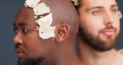 Buy stock photo Beauty, thinking and men with flowers in studio for cosmetics, wellness and spa treatment. Dermatology, aesthetic and face of people for natural skincare, self confidence or health on blue background