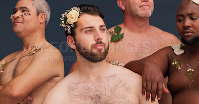 Buy stock photo Beauty, skincare and men with flowers in studio for cosmetics, wellness and spa treatment. Dermatology, aesthetic and people with plants for natural skin, self confidence or health on blue background