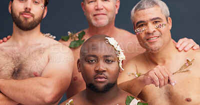 Buy stock photo Portrait, skincare and men with flowers in studio for cosmetics, wellness and spa treatment. Lgbtq, aesthetic and people with plants for natural skin, self confidence or beauty on blue background