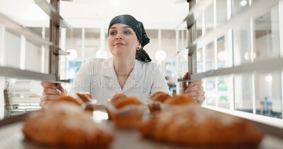 Buy stock photo Croissant, bakery and dessert with woman in kitchen for coffee shop, food industry and breakfast. Shelf, chef and nutritionist with baker and pastry trolley in restaurant for baking, hotel and cafe