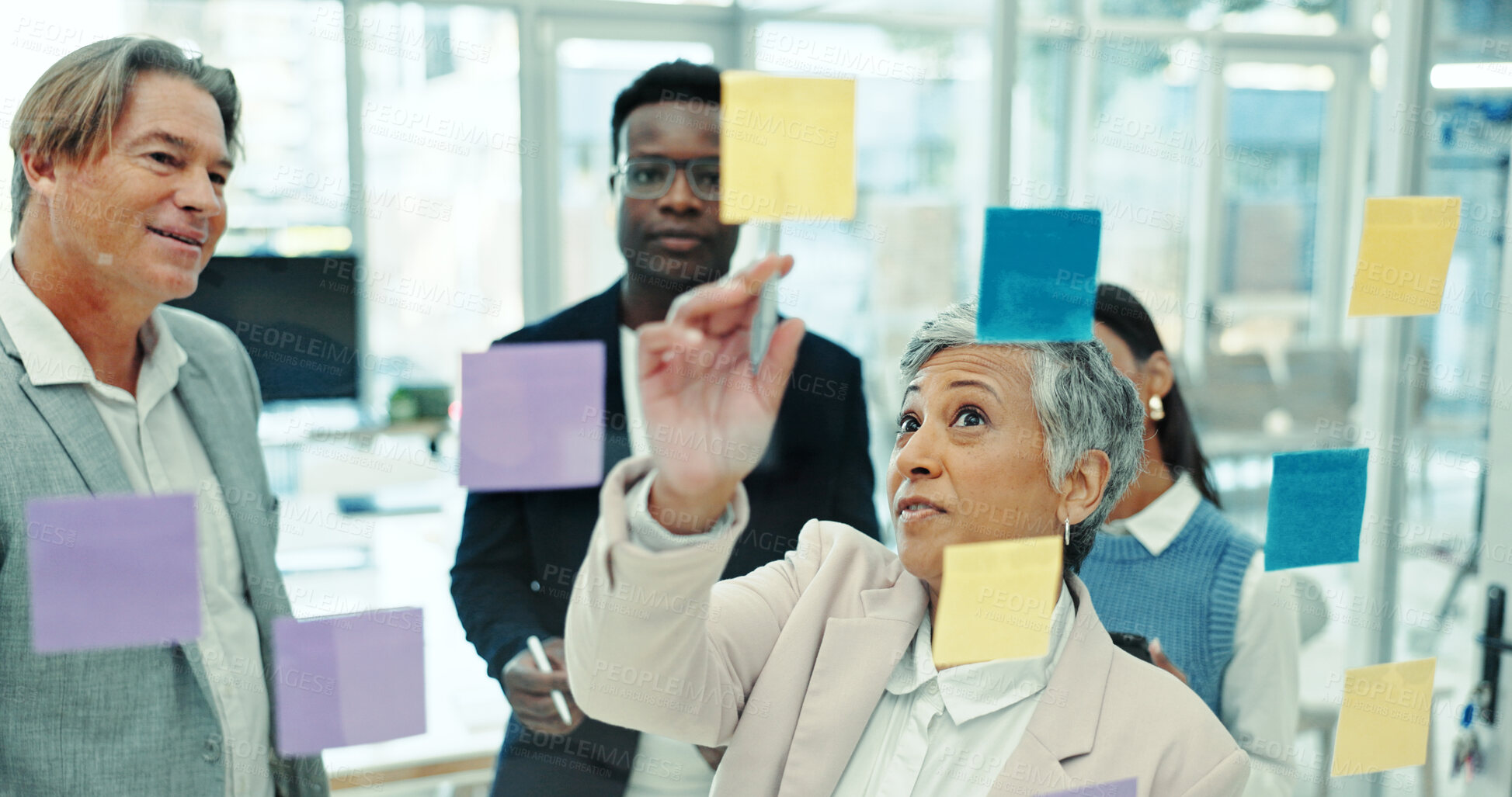 Buy stock photo Glass wall, group and business people in office with sticky note, information or meeting for project. Collaboration, board and team of creative journalists planning media press release in workplace.