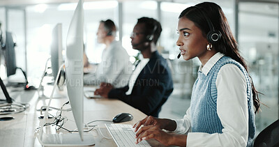 Buy stock photo Call center, computer and typing with Indian woman in support office for customer service. Contact us, feedback and research with person speaking on headset in workplace for advice or virtual help