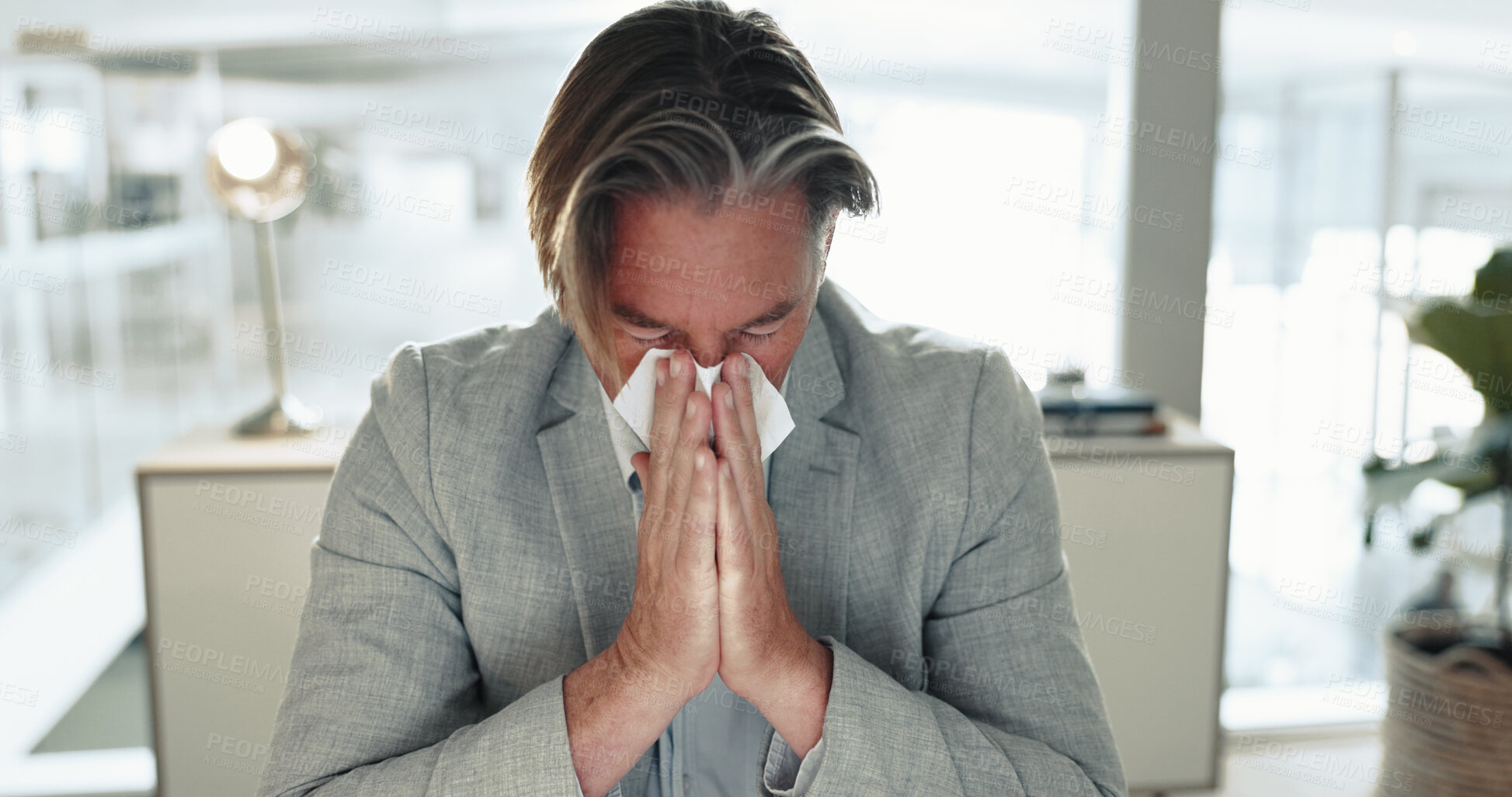 Buy stock photo Sick, mature man and blowing nose with tissue for viral infection, hayfever or allergies at office. Senior, male person or employee with virus, cold or flu for influenza, cough or sneeze at workplace