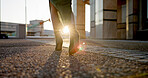 Business, walking and feet of woman in city with sunrise, travel and metro station for transport. Sunshine, urban sidewalk and shoes of businesswoman on morning commute with light flare on ground