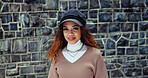 Portrait, fashion and woman in city, confidence and commute with pride, trendy clothes and wall background. Face, happy person and girl with stylish outfit, travel and tourism with smile and hipster