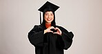 Heart hands, graduation and smile with portrait of asian woman in studio for success, college degree or award. Achievement, education and university student with person on white background for mockup