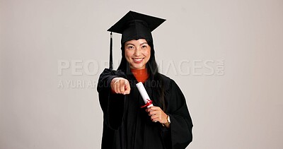 Buy stock photo Pointing, graduation and diploma with portrait of asian woman in studio for success, college choice or pov. Decision, education and university option with person on white background for mockup