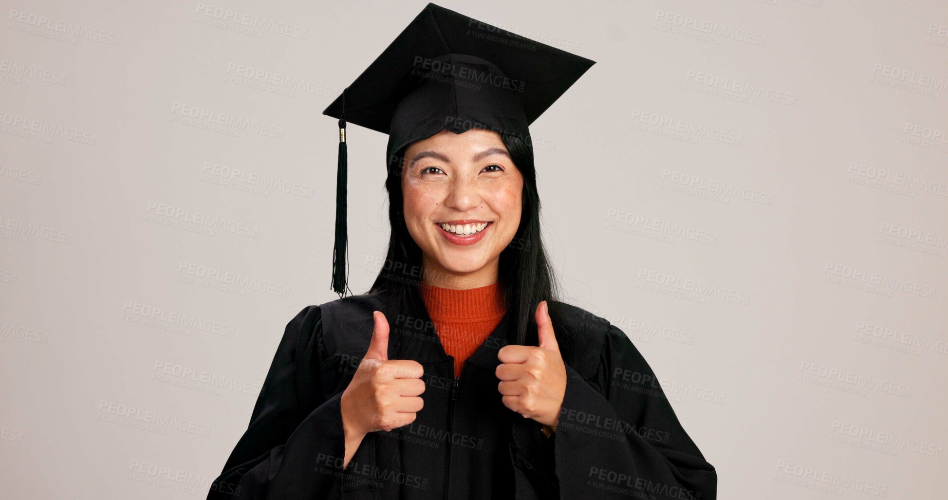 Buy stock photo Thumbs up, graduation and smile with portrait of asian woman in studio for success, college degree or award. Achievement, education and university student with person on white background for mockup