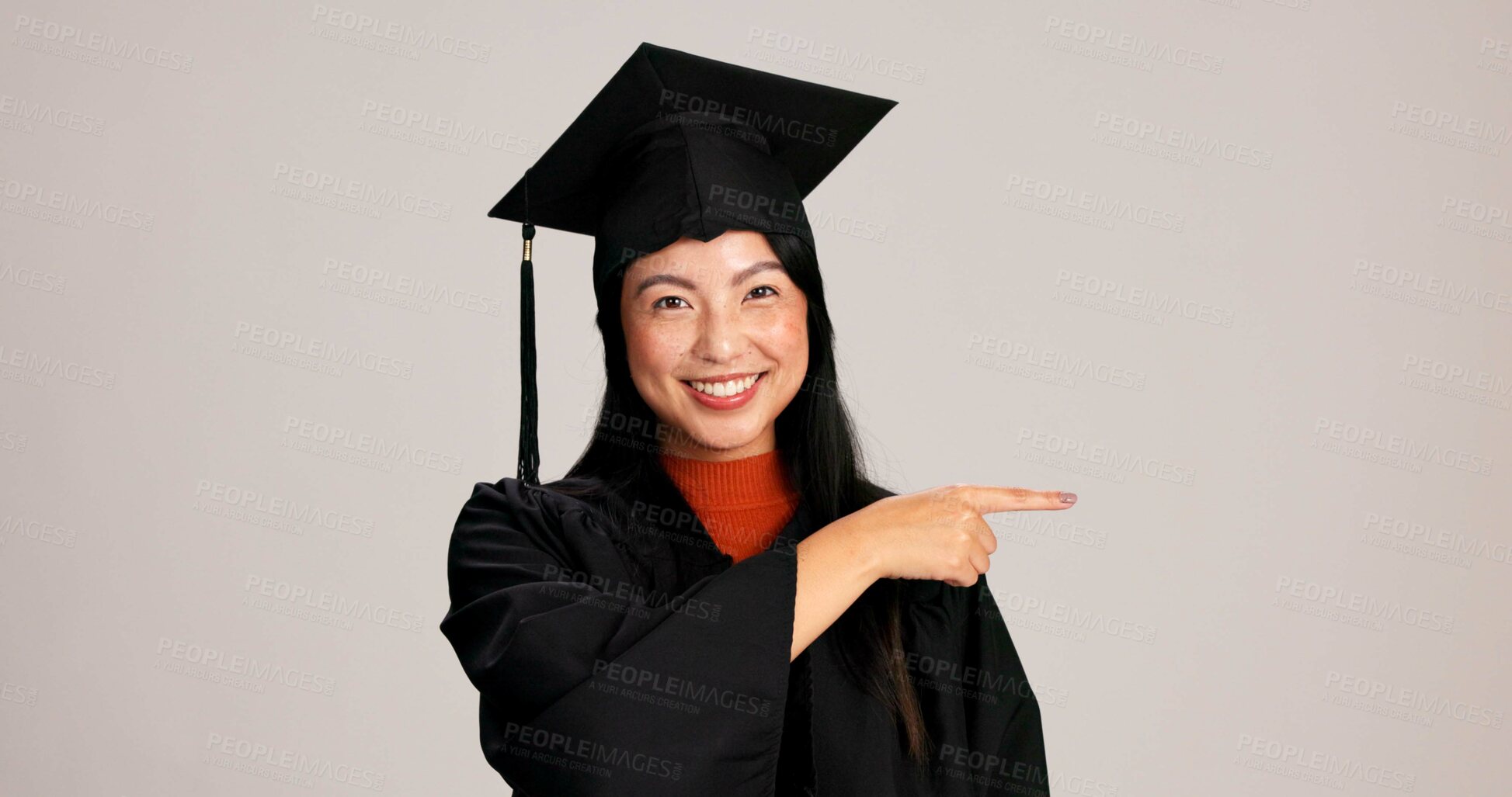 Buy stock photo Woman, studio and university student with pointing on  graduation for career advice, instructions and tips. Asian person, portrait and happy in confidence for education and scholarship opportunity