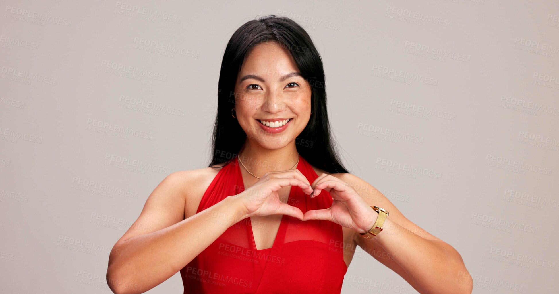 Buy stock photo Happy woman, portrait and heart hands, love sign or gesture for romance on grey studio background. Asian female person, smile and emoji with shape, symbol and kindness for valentines day date mockup