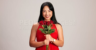 Buy stock photo Woman, studio background and smile with rose on portrait for love, care and valentines day celebration in Japan. Japanese person, romance and happy in red dress with flower as anniversary gift