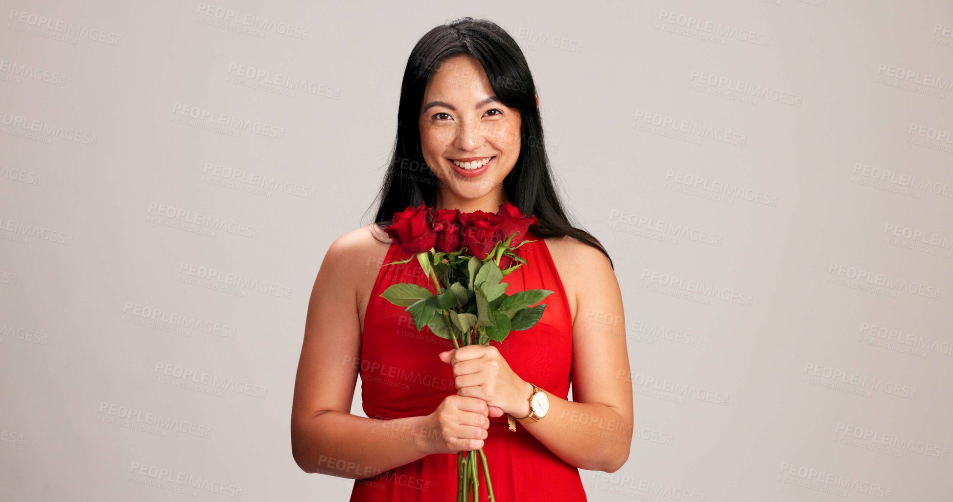 Buy stock photo Woman, studio background and smile with rose on portrait for love, care and valentines day celebration in Japan. Japanese person, romance and happy in red dress with flower as anniversary gift