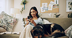 Typing, dog and phone with woman on sofa for bonding, social media post and pet adoption. Happiness, scroll and animal rescue with person in living room at home for foster care, search and online app