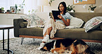 Girl, home and dog with tablet, wellness and online for bonding with love, companion and peace. Female person, tech and pet care for emotional support in living room for happiness, streaming or relax