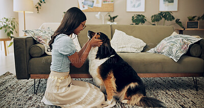 Buy stock photo Home, love and woman with dog, smile and owner with loyalty for companion, lounge and care in apartment. Living room, chilling and bonding with pet, person and comfortable with animal in house