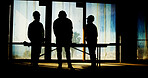 Silhouette, workers or architect with blueprint in building for site inspection, property development or maintenance. Construction, people or reading floor plan for remodeling project or architecture
