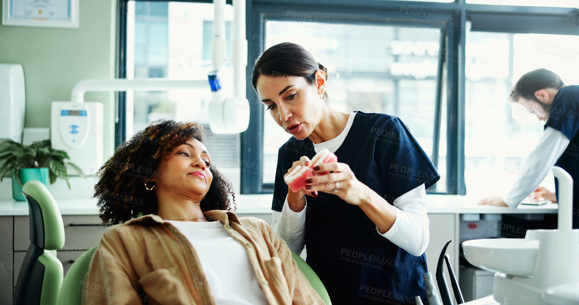 Buy stock photo Consulting, mouth model and dentist with woman in clinic for cleaning, dental hygiene and demonstration. Healthcare, dentistry and patient with hygienist for extraction, oral care and medical service