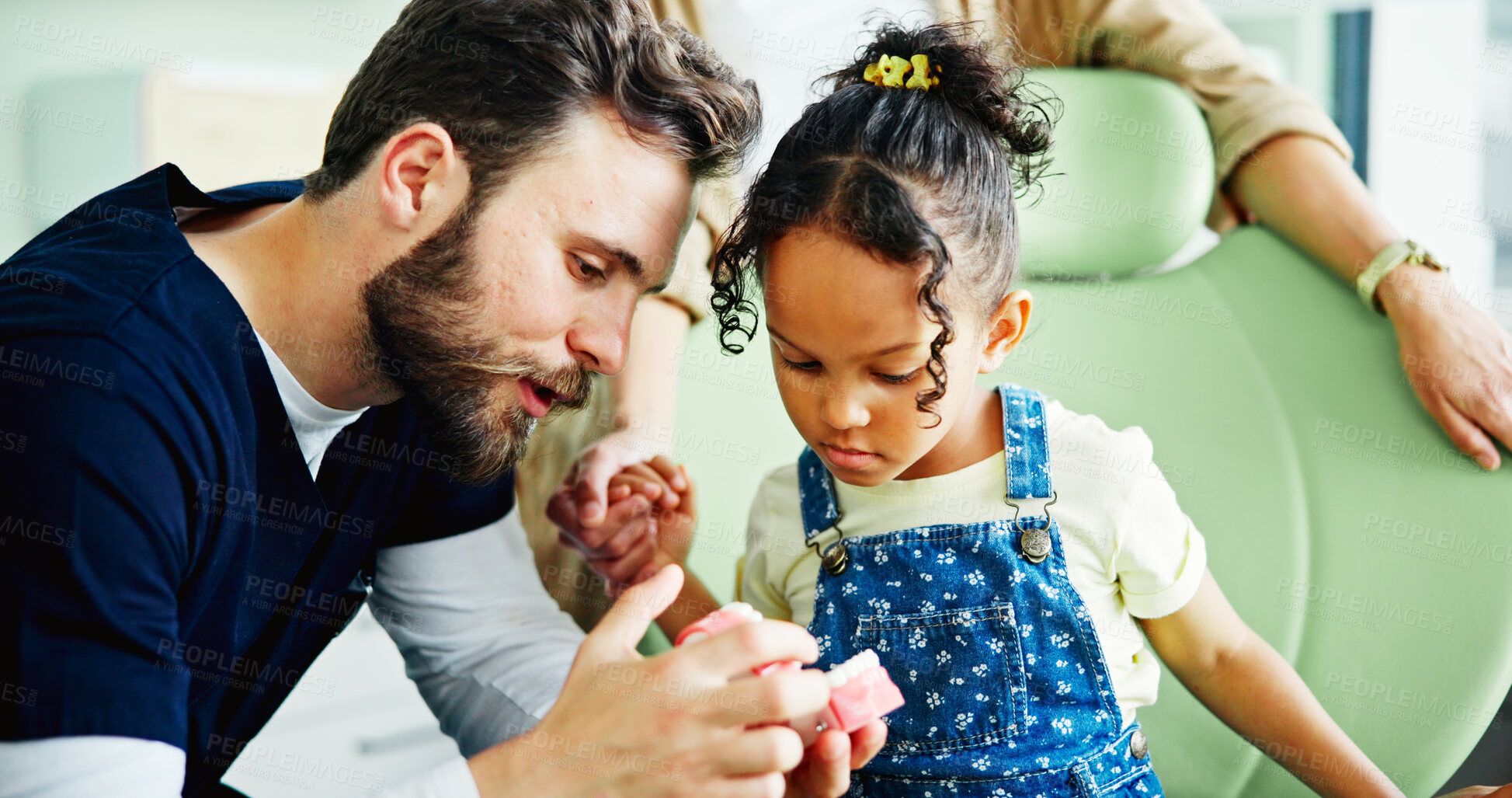 Buy stock photo Dentist, mouth model and man with child in clinic for cleaning, dental hygiene and gum wellness. Healthcare, dentistry and young patient with hygienist for consulting, oral care and medical services