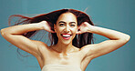 Portrait, hair care and happy woman with beauty, wind or texture for growth on studio background. Hairstyle, face and model in makeup cosmetics for hairdresser treatment, confident and laugh at salon