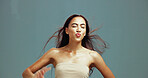 Beauty, skincare and woman with pout kiss for lipstick results, glowing skin and natural makeup. Eyes closed, girl and jumping on studio background with mockup space, collagen treatment and flirting