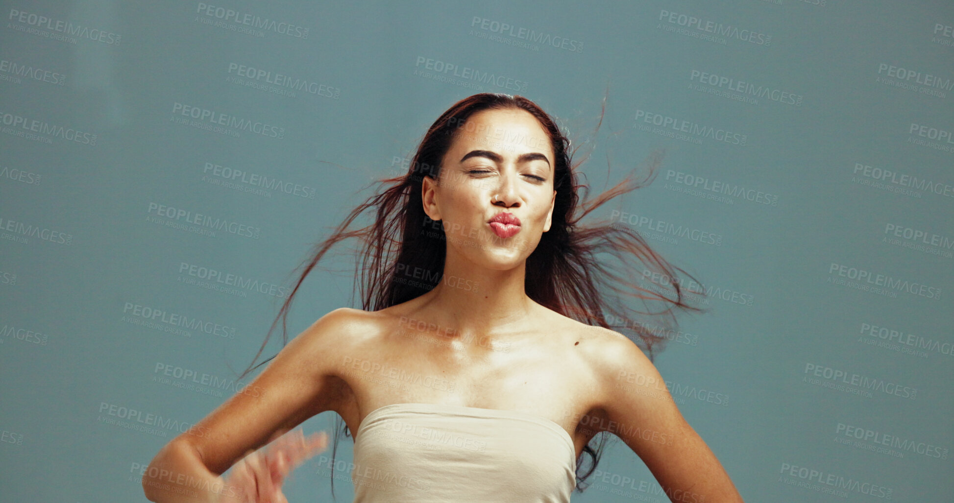 Buy stock photo Beauty, skincare and woman with pout kiss for lipstick results, glowing skin and natural makeup. Eyes closed, girl and jumping on studio background with mockup space, collagen treatment and flirting