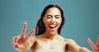 Buy stock photo Portrait, smile and woman with peace sign for beauty, glow and excited on studio background. Face, laugh and model with v hand, gesture and makeup cosmetics for skincare, flirt emoji or spa treatment