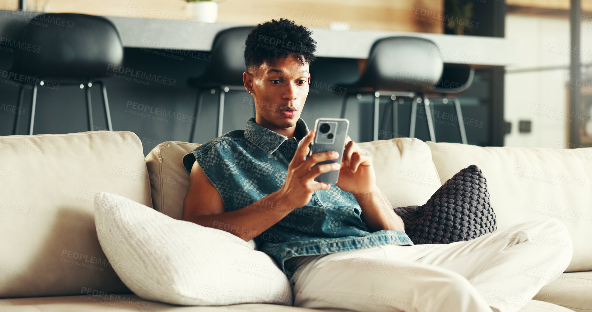Buy stock photo House, surprise and man on sofa, smartphone and typing with social media, announcement and network. Apartment, person and guy with cellphone, shocked and message to contact, app or email notification