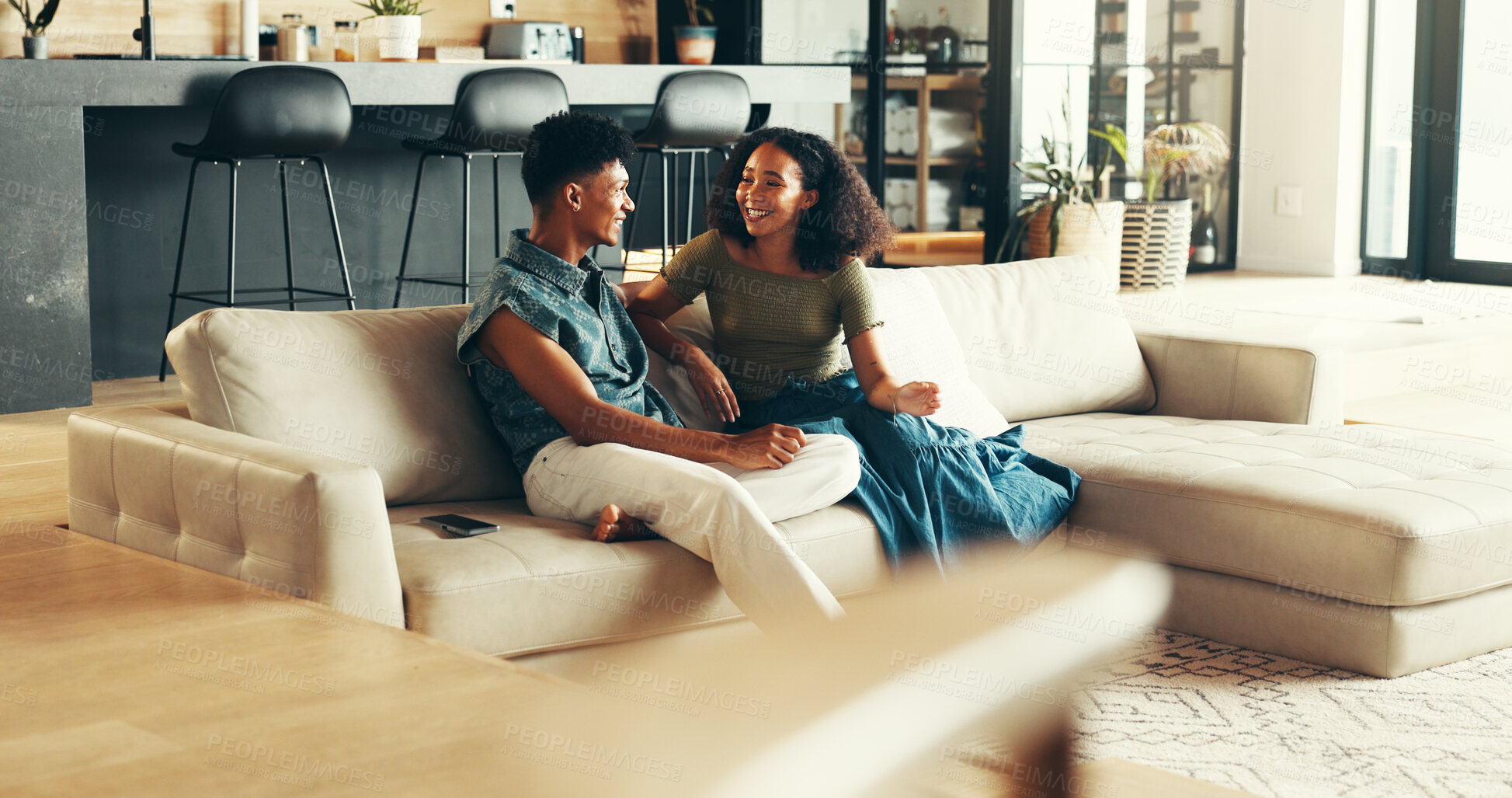 Buy stock photo Happy couple, smile and conversation in living room in bonding together, relax or peace on weekend. Woman, man and talking with comfort in home or apartment on couch for discussion, chatting and care