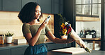 Flowers, phone and picture with woman in kitchen for social media, floral bouquet and delivery. Gift, happiness and photography with person and present at home for valentines day, online post or love