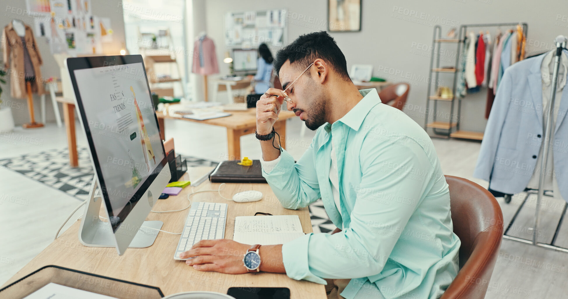 Buy stock photo Small business, man and stress on computer as fashion designer with clothes or logistics deadline. Male person, entrepreneur and tired or exhausted with production crisis, backlog and online orders