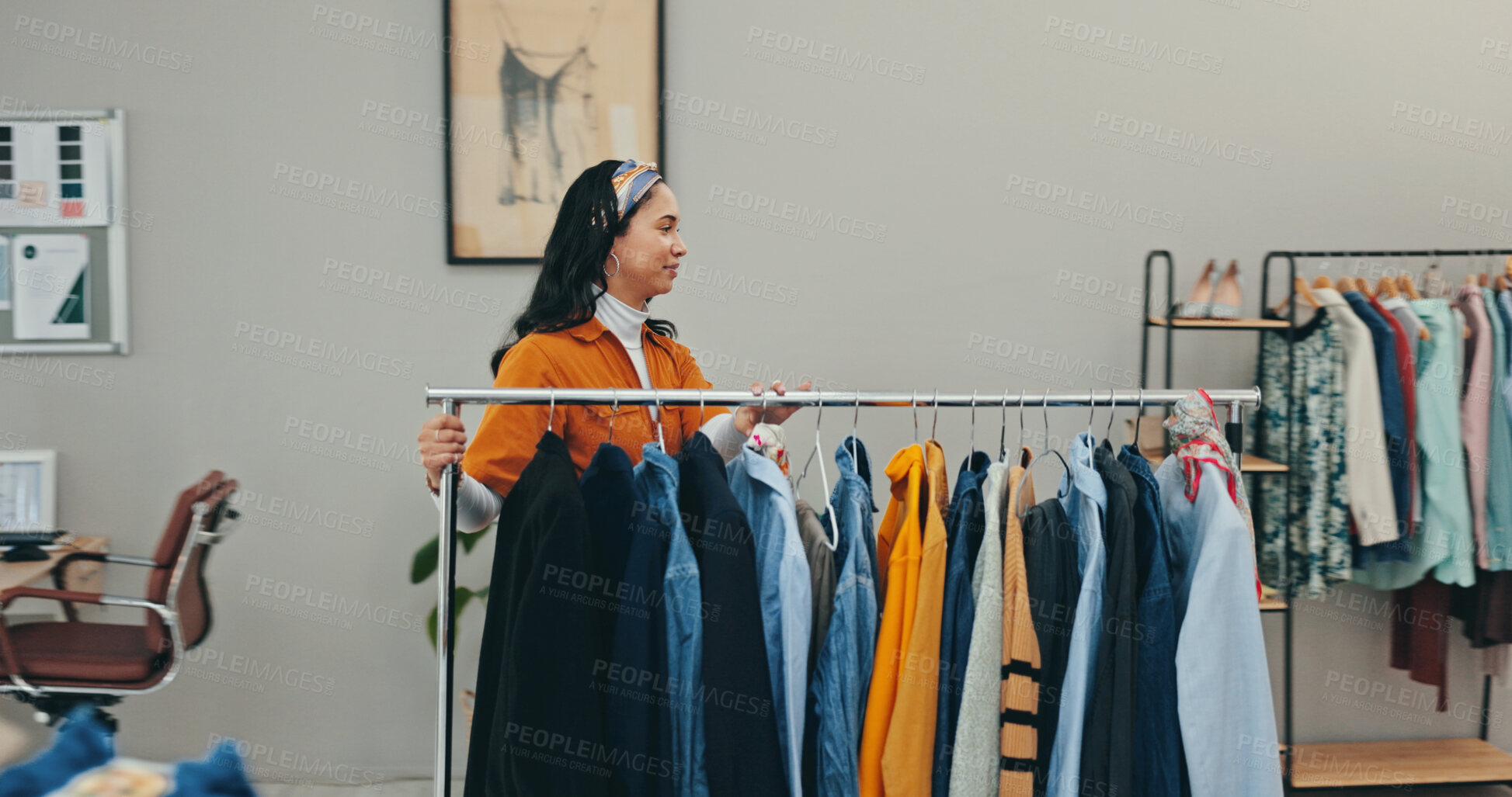 Buy stock photo Clothing rack, creative and outfit with fashion designer woman in textile workshop for decision. Choice, options and wardrobe with style director in office for clothes production or manufacturing