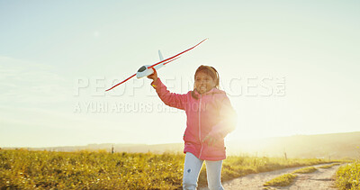 Buy stock photo Happy kid, toy airplane and running outdoor for game, freedom or travel on mockup space. Smile, girl and child play with plane in sky for flight, vacation or sunrise on countryside path for adventure