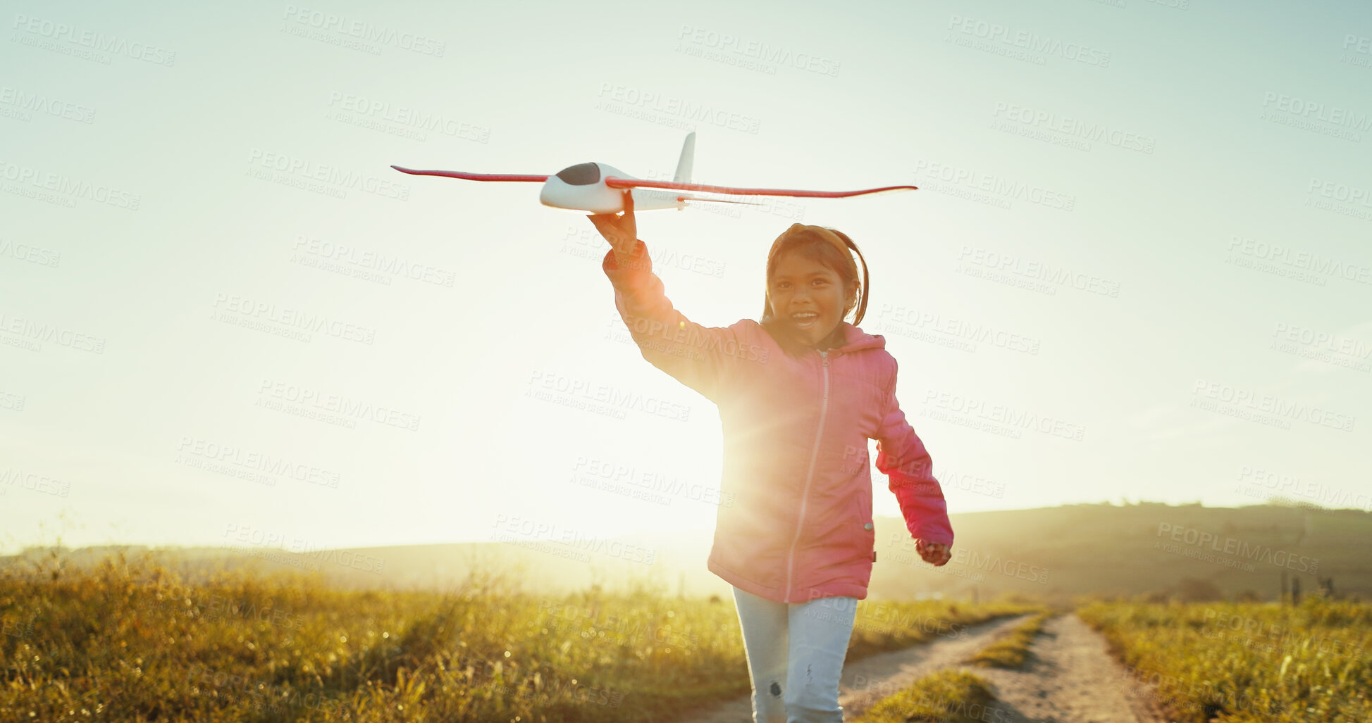 Buy stock photo Happy child, toy airplane and running outdoor for game, freedom or travel on mockup space. Smile, girl and kid play with plane in sky for flight, vacation or sunrise on countryside path for adventure