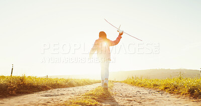 Buy stock photo Child, outdoor and play with airplane at sunrise for game, freedom or travel on mockup space. Back, girl or kid running with plane in sky for flight, toy or vacation on countryside path for adventure