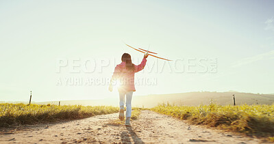 Buy stock photo Kid, running outdoor and play with airplane for game, freedom and travel on mockup space. Back, girl and child with toy plane by sky for flight, vacation and sunrise on countryside path for adventure