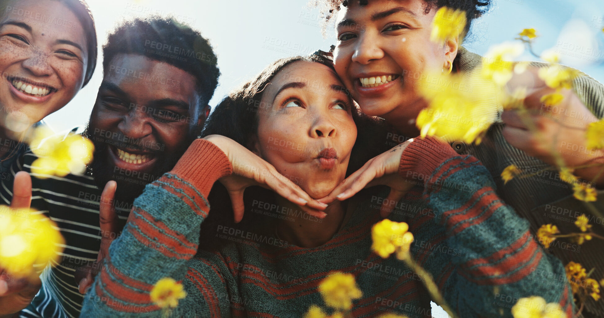 Buy stock photo People, friends and funny face with flowers field for summer adventure, portrait and nature in countryside. Group, park and bonding for holiday, social networking and blue sky for sunshine or spring