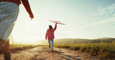 Buy stock photo Girl, child and running with airplane in field for fantasy game, exploring and fun imagination with space. Back, kid and flying with toy for sensory play, development and travel adventure in meadow