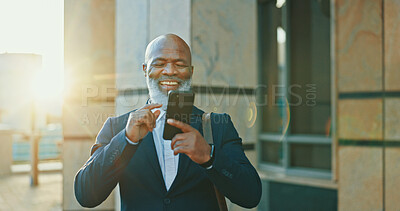 Buy stock photo Cellphone, travel and businessman in city with communication, social networking or connectivity online. Happy, phone and African male lawyer with email for legal case information on commute in town.