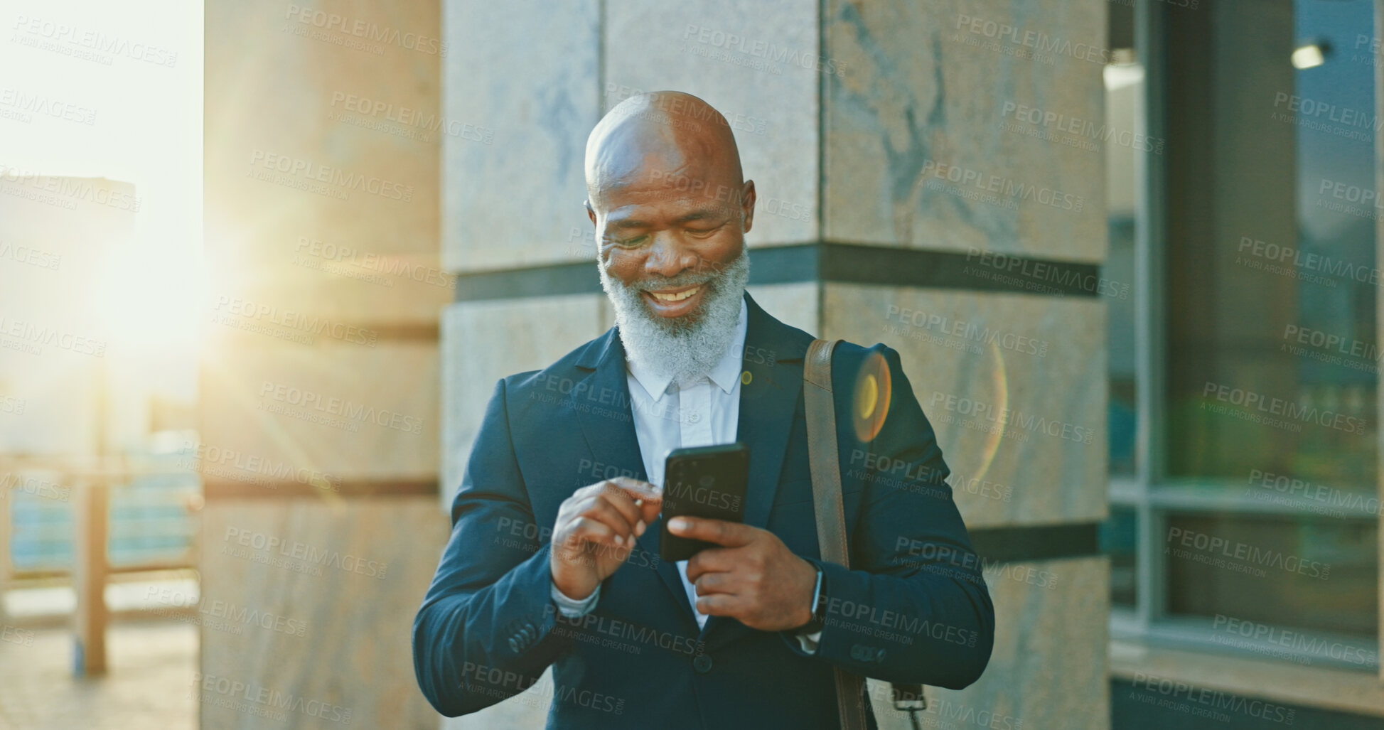 Buy stock photo Black man, city attorney and phone for travel, agenda and online for consulting on legal case. Male person, urban town and journey to office building for justice, counsel client and message on app