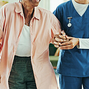 Physiotherapy, holding hands and help with walking stick for support ...