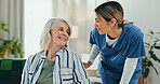 Senior woman, caregiver and smile with discussion for healthcare, comfort and treatment in elderly care at home. People, nurse and communication for help, conversation and checkup in retirement