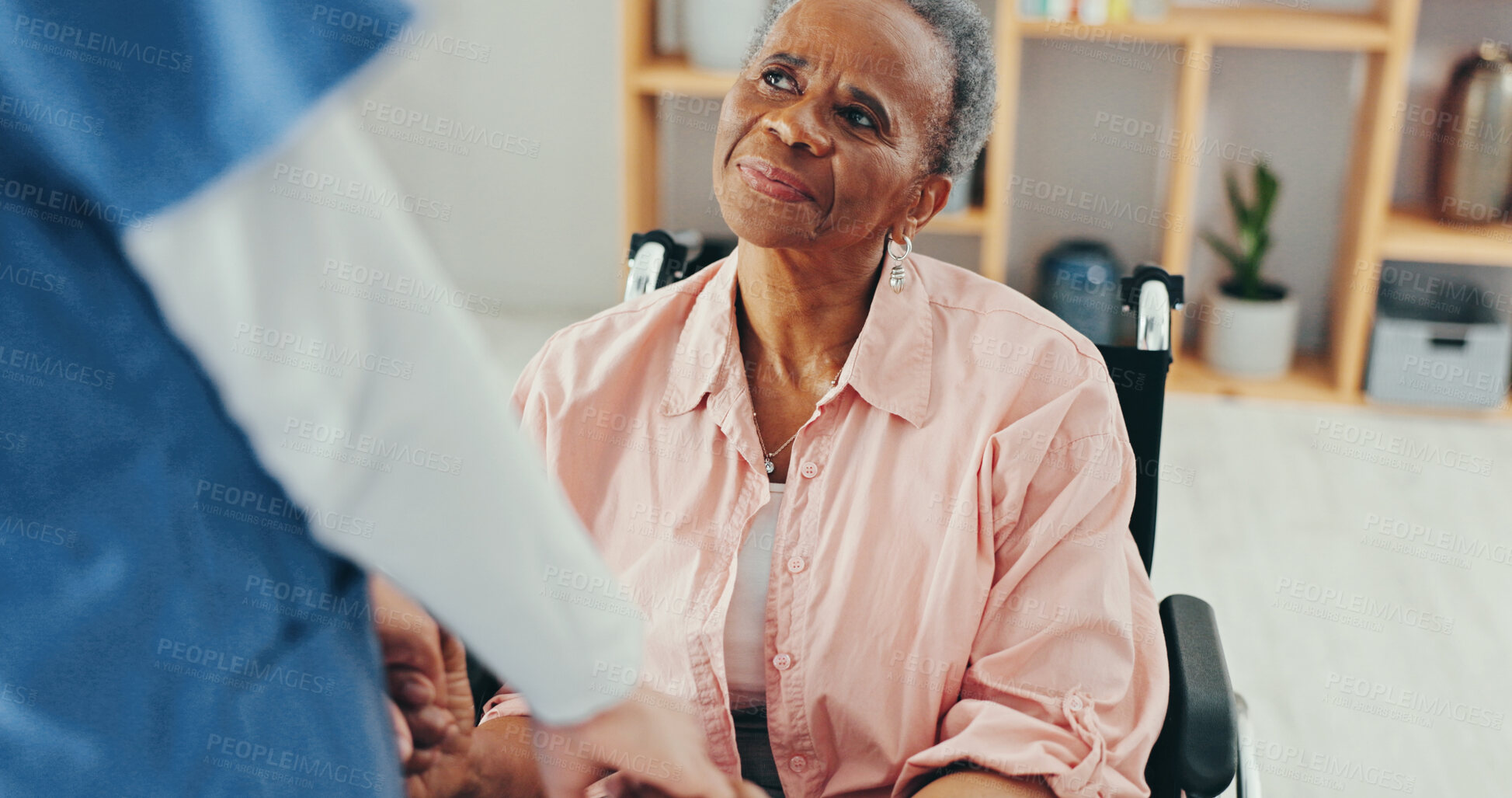 Buy stock photo Senior woman, wheelchair and caregiver with holding hands, support and console with recovery in retirement. Nurse, patient and elderly person with disability, empathy and rehabilitation in house