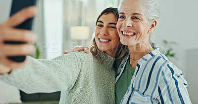 Buy stock photo Woman, senior mom and selfie in home for memory, hug and care with bonding for post on mobile app. People, mother and daughter with profile picture, photography and social media in family house