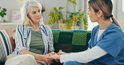 Buy stock photo Sad, senior woman and holding hands with nurse for empathy, compassion or comfort with grief, loss or support. Nursing home, caregiver and depressed patient on sofa for medical help and health advice